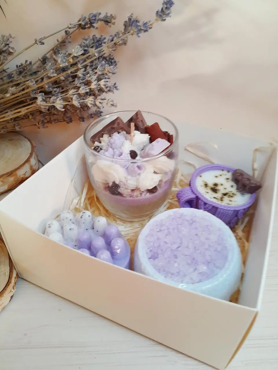 Spa set with rolled towels, aroma oil, candle and roses