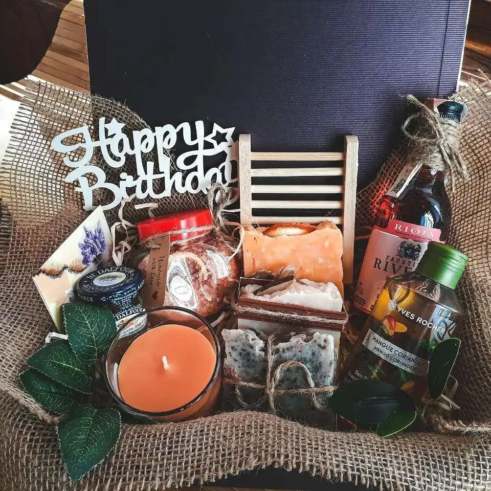Spa set with blue bath salt, candles, towel and blossom branch