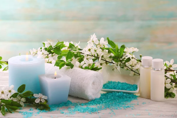 Spa composition with candles, flowers and towels